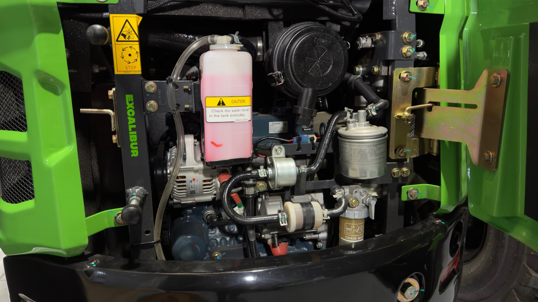 Close-up of a green heavy machinery engine, showcasing components like filters and pumps.