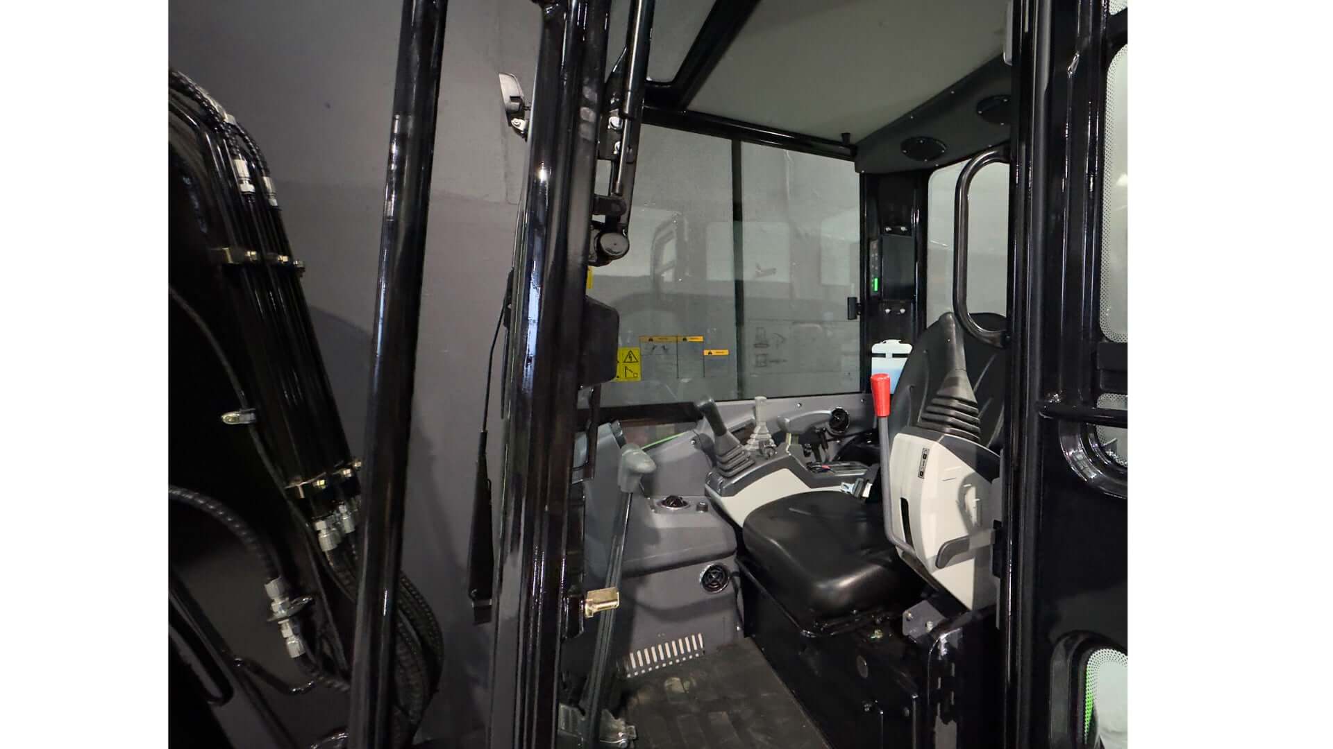 Interior view of the 3.8 Tonne Excavator cabin showcasing controls and operator seat.
