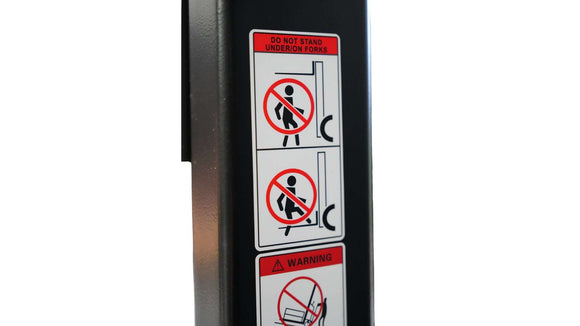 Warning labels on an electric pallet jack advising against standing under forks.