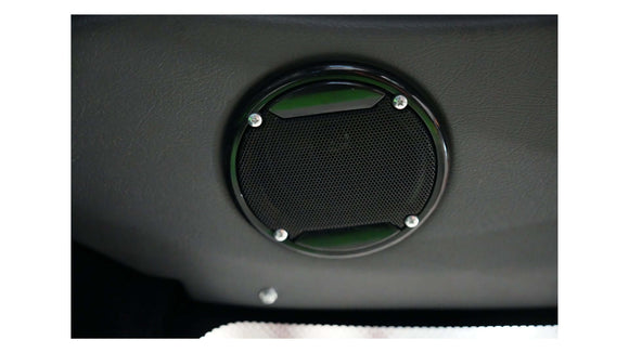 Close-up of a sleek black speaker well integrated into the interior of a vehicle.