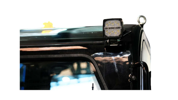 LED work lamp mounted on excavator roof for enhanced visibility in construction projects.