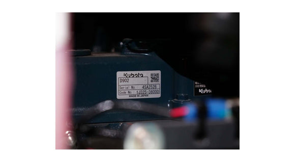 Close-up of a Kubota engine label showing serial and model numbers for identification.